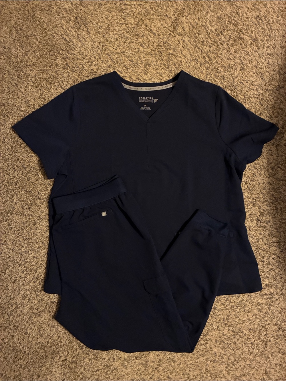 Fabletics scrub set with one pocket top and cargo joggers in navy blue